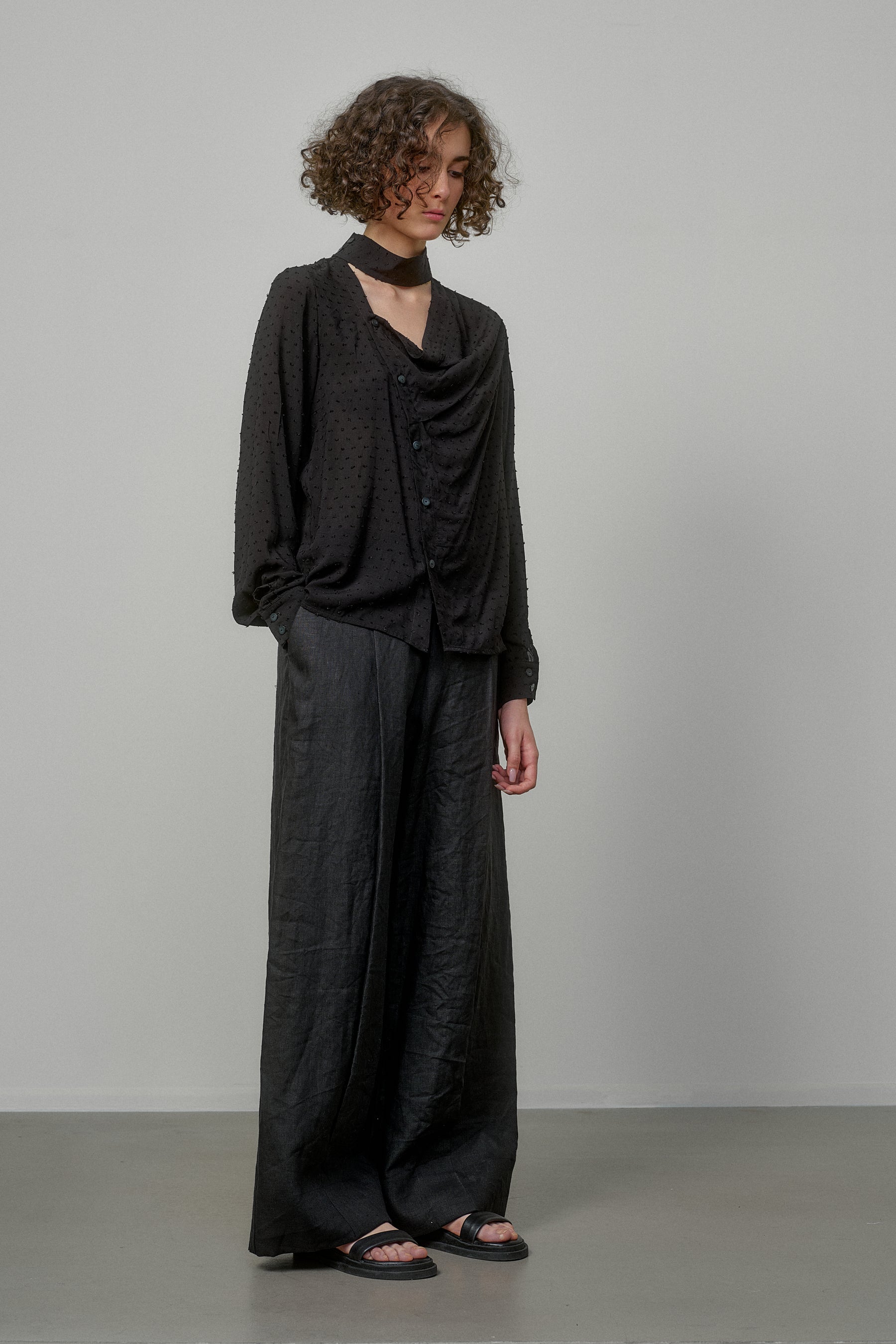 BLACK SHIRT WITH DRAPED FRONT AND HIGH NECK COLLAR