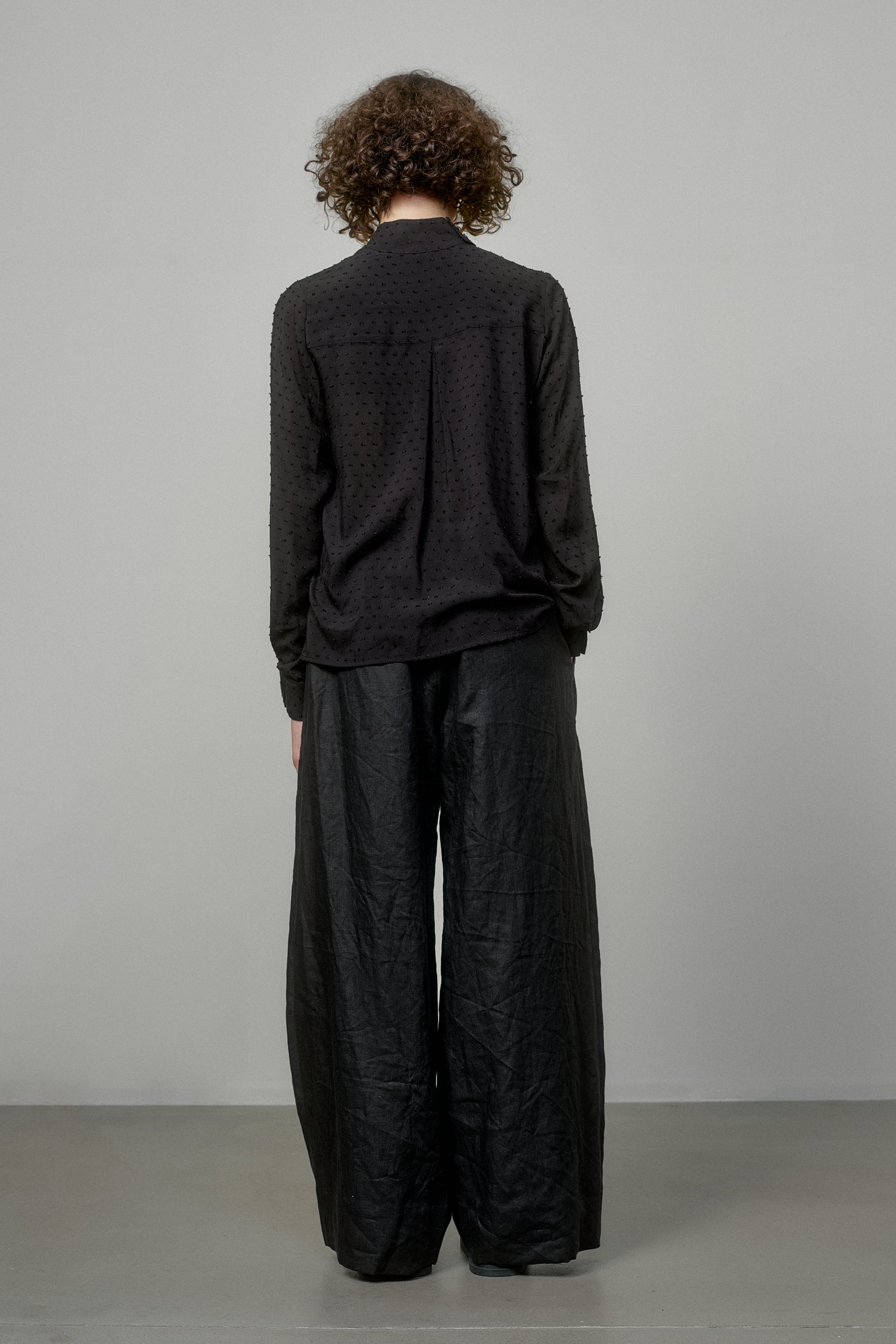 BLACK SHIRT WITH DRAPED FRONT AND HIGH NECK COLLAR