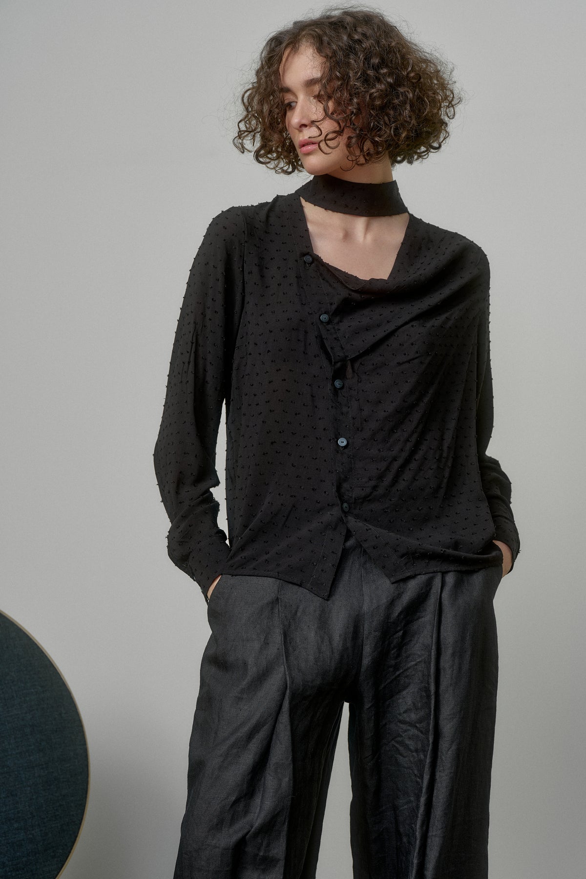 BLACK SHIRT WITH DRAPED FRONT AND HIGH NECK COLLAR