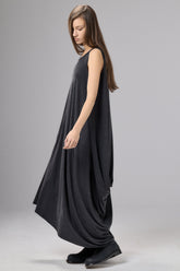 Woman wearing a black sleeveless dress on a gray background