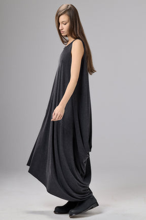 Woman wearing a black sleeveless dress on a gray background